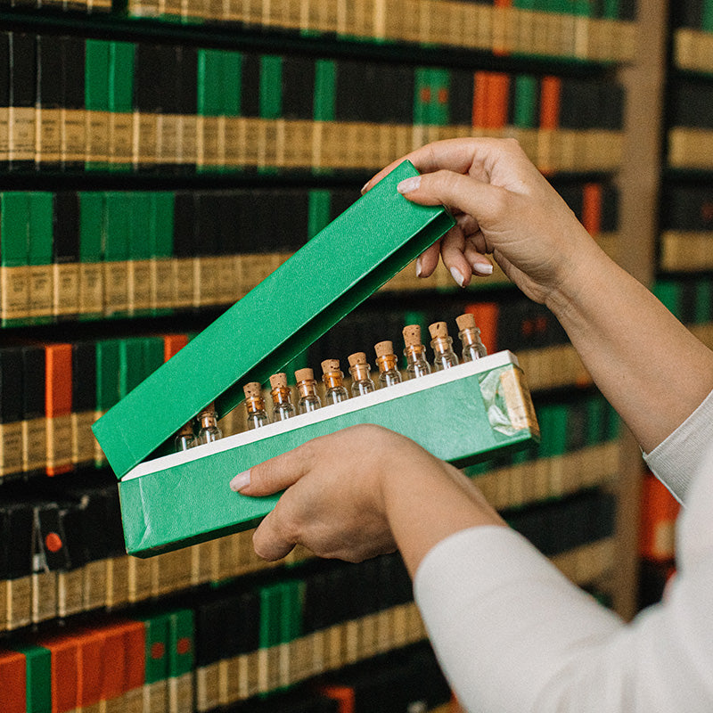 Practitioner Opening a Box With Homeopathy Remedies