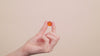 A video of a woman's hand touching a gummie