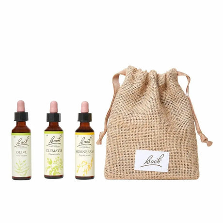 There are three dropper bottles with essences from left to right: Bach™  Original Flower Remedies Olive, Bach™  Original Flower Remedies Clematis and Bach™  Original Flower Remedies Hornbeam. Next to the last essence there is a burlap bag with the Bach™  logo on it.