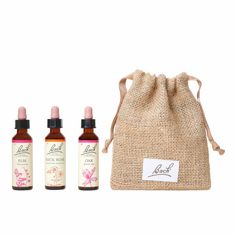 There are three dropper bottles with essences from left to right:  Bach™  Original Flower Remedies Elm, Bach™  Original Flower Remedies Rock Rose and Bach™  Original Flower Remedies Oak. Next to the last essence  there is a burlap bag with the Bach™  logo on it.