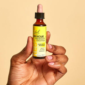  A hand holding the Rescue® Remedy Dropper 20ml 