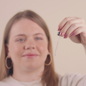 Video of a woman putting 4 drops with the dropper in her mouth.