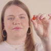  video of a woman eating a vitamin gummie with a happy face