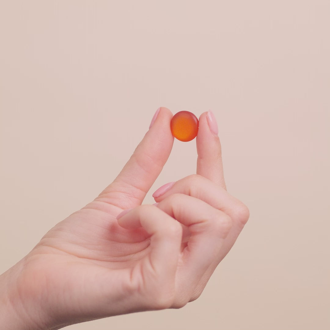Video of a woman's hand touching a gummie